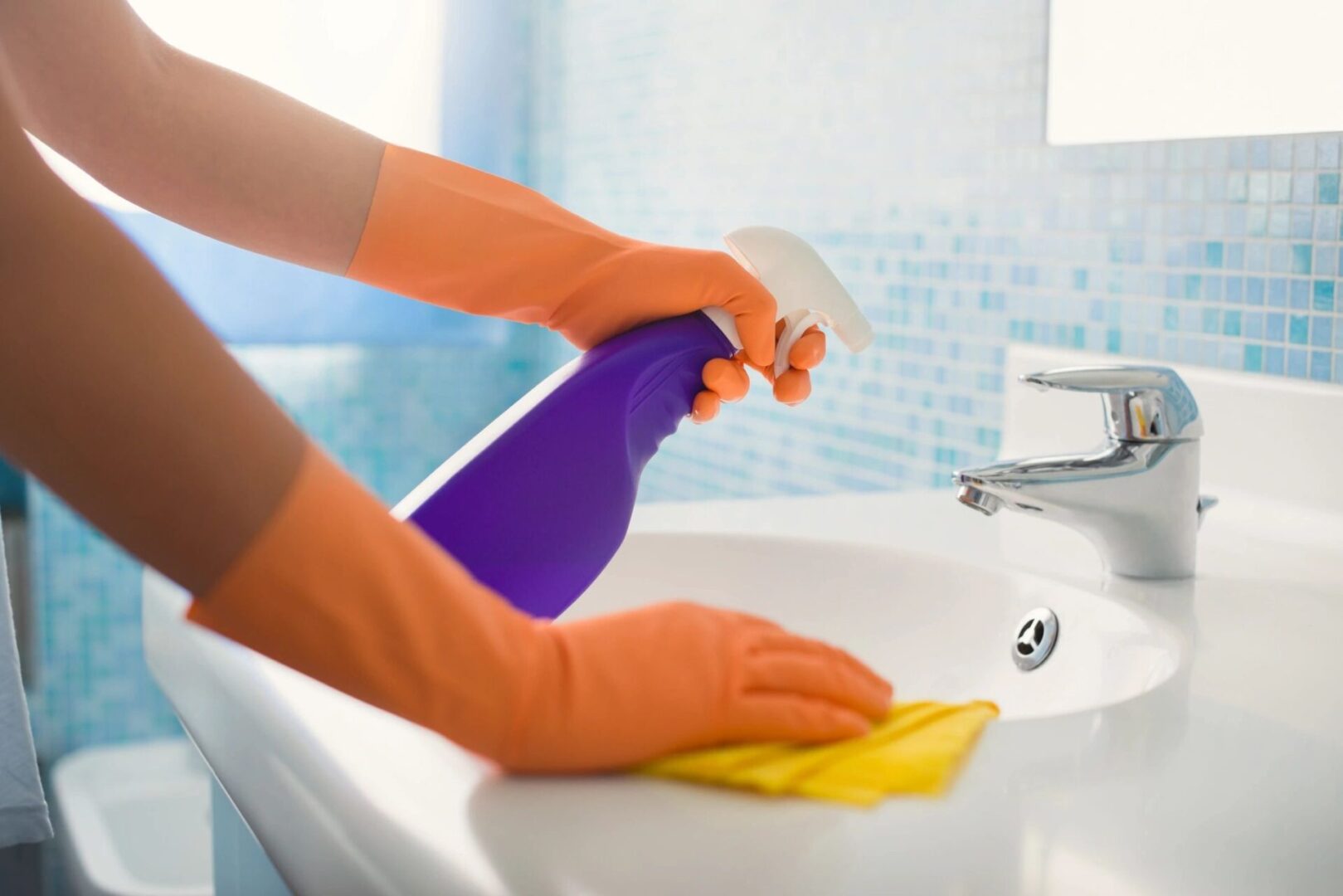 A person cleaning a sink