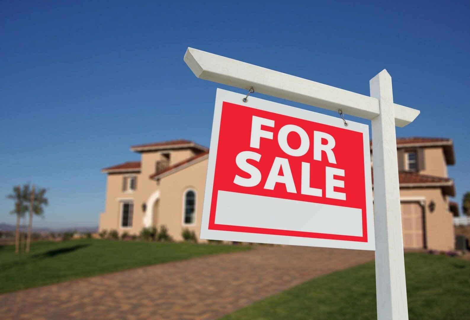 A for sale sign in front of a house