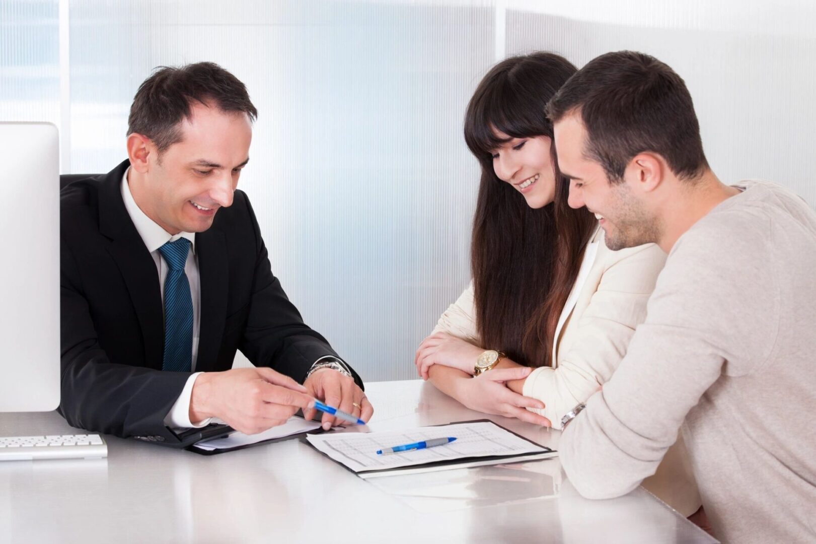 A realtor talking to a man and woman