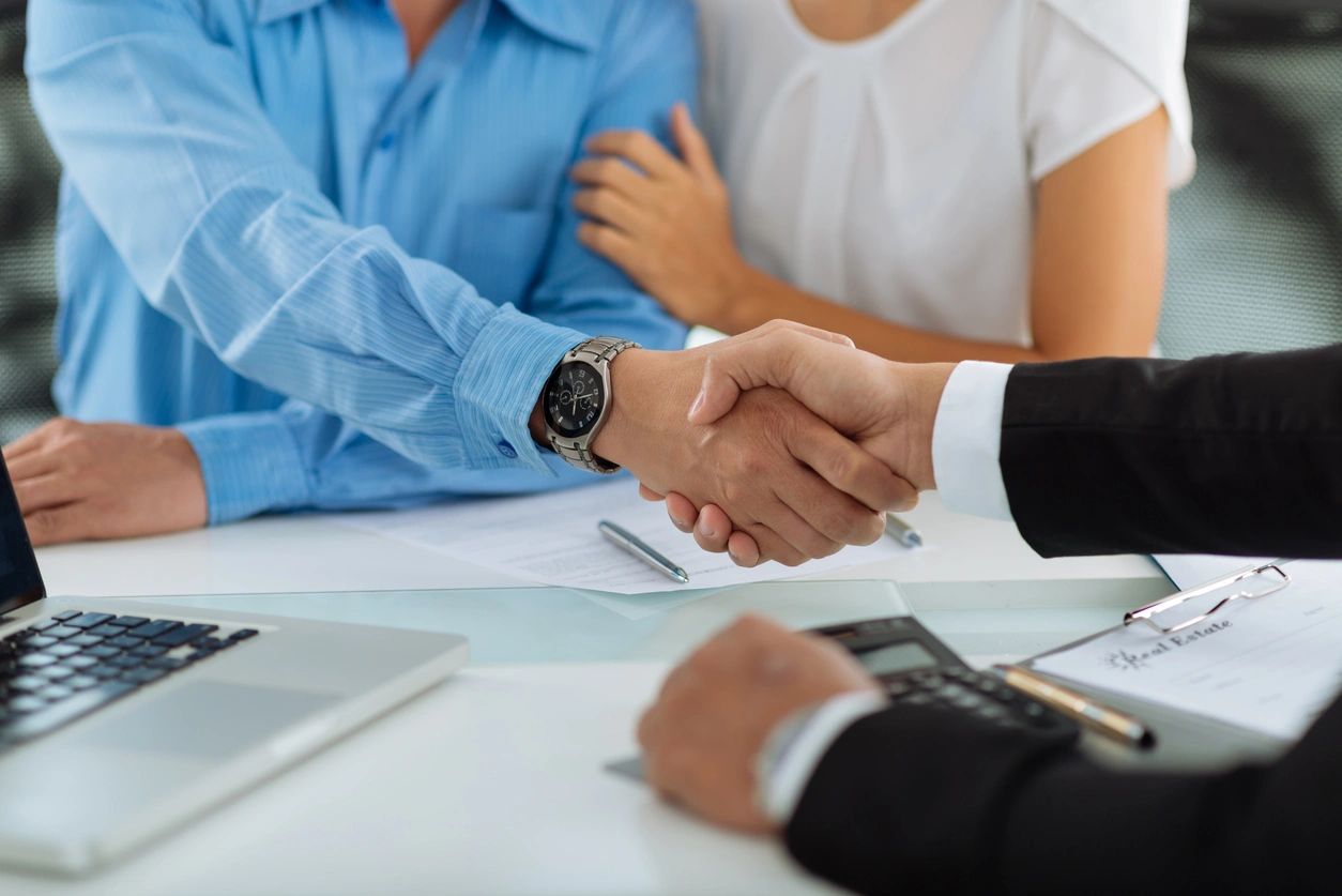 A realtor shaking hands with a man