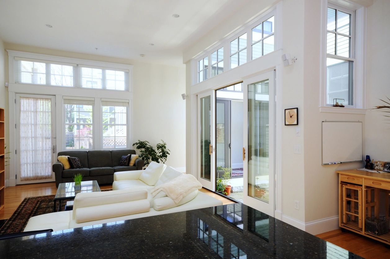 A living room with gray and white sofas